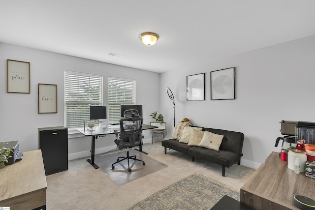 office area featuring carpet flooring, visible vents, and baseboards