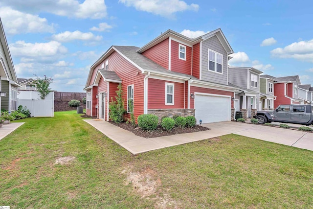 view of property with a garage and a front lawn