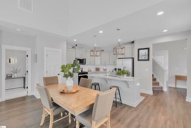 dining area featuring light hardwood / wood-style floors and sink