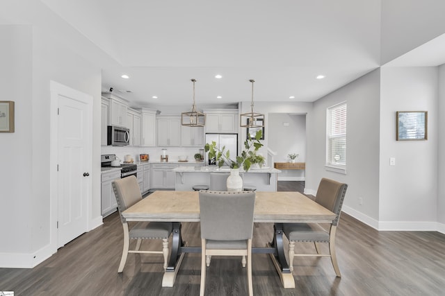 dining space with dark wood-style floors, baseboards, and recessed lighting