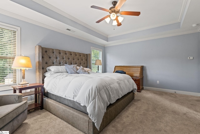 bedroom featuring crown molding, a raised ceiling, light colored carpet, and ceiling fan