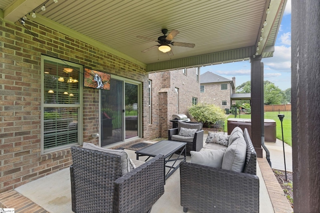 view of patio with grilling area, an outdoor living space, and ceiling fan