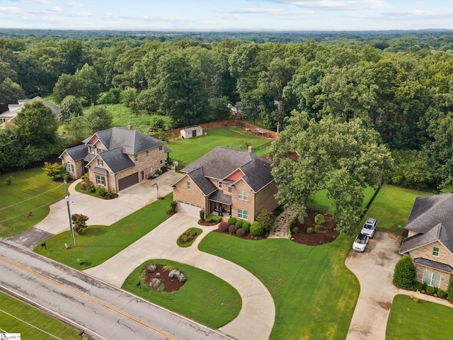 drone / aerial view featuring a forest view