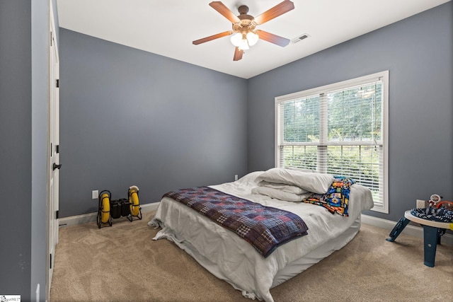 bedroom featuring light carpet and ceiling fan