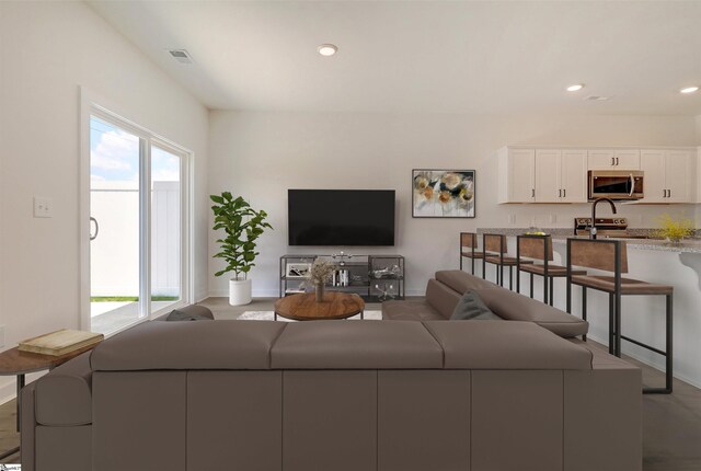 living area with recessed lighting and visible vents