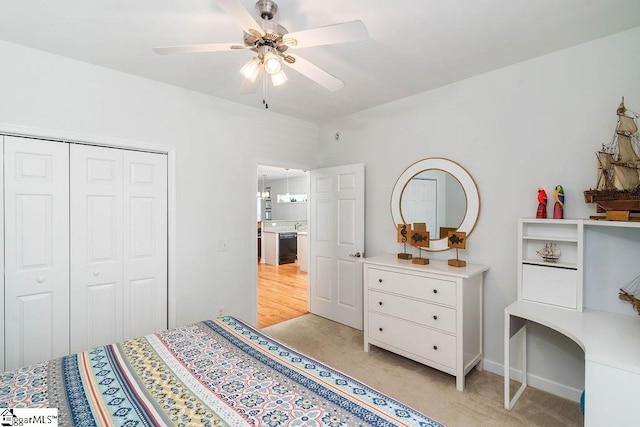 carpeted bedroom featuring a closet and ceiling fan