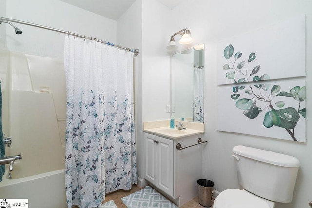 full bathroom with vanity, shower / tub combo, and toilet