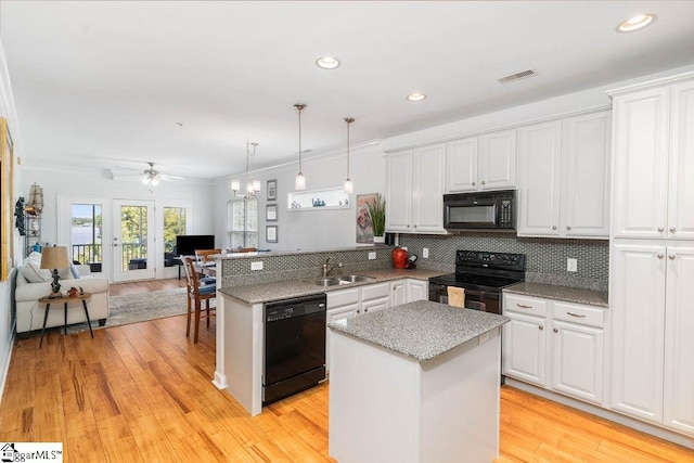 kitchen with black appliances, ceiling fan, decorative backsplash, sink, and light hardwood / wood-style floors