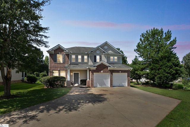 view of front facade featuring a garage, concrete driveway, brick siding, and a yard