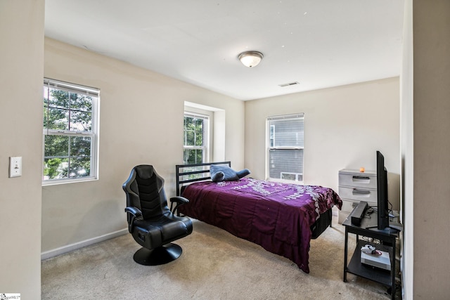 carpeted bedroom featuring visible vents and baseboards