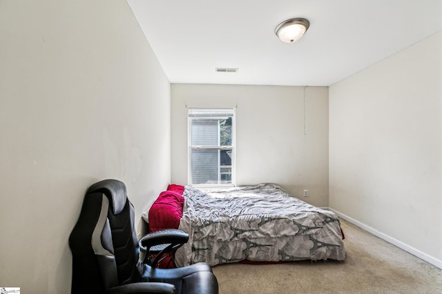 carpeted bedroom with baseboards and visible vents