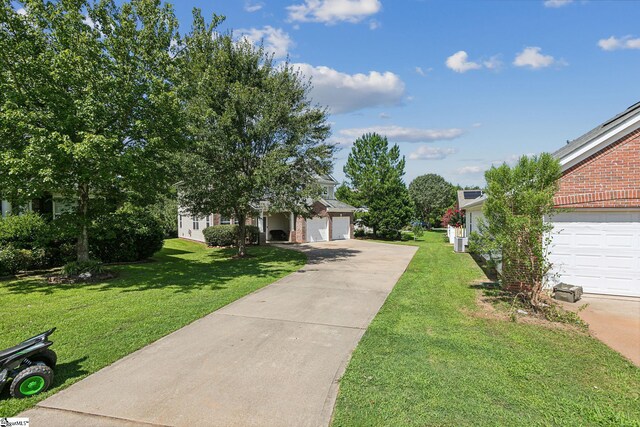 obstructed view of property featuring a garage and a front yard