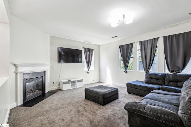 living room with carpet, a fireplace, and baseboards