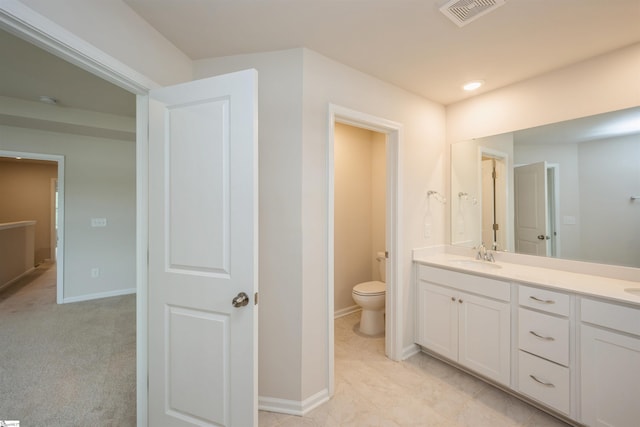 bathroom with vanity, tile patterned flooring, and toilet