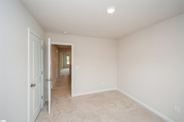 empty room featuring light carpet