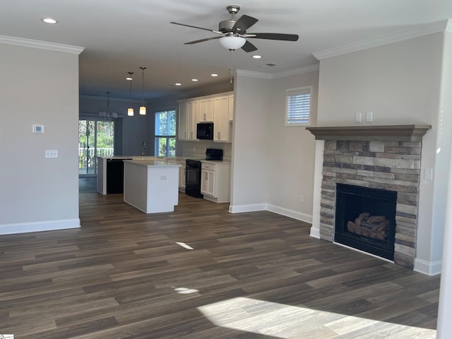 kitchen featuring a ceiling fan, a kitchen island, black appliances, open floor plan, and white cabinetry