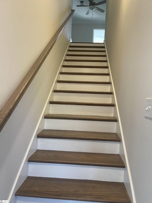 staircase featuring ceiling fan and crown molding