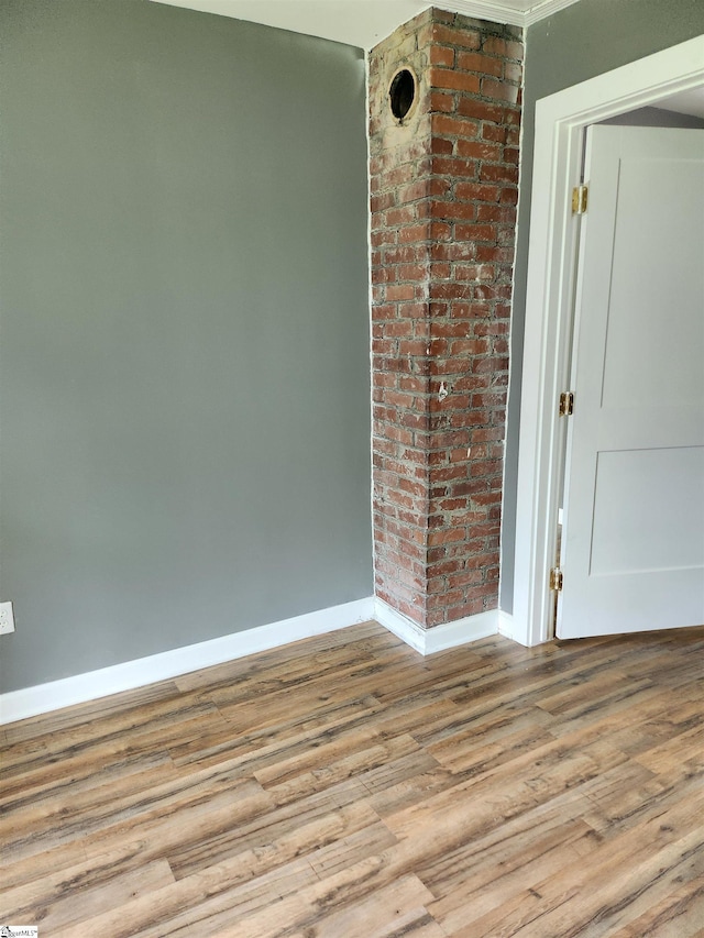 unfurnished room featuring baseboards and wood finished floors