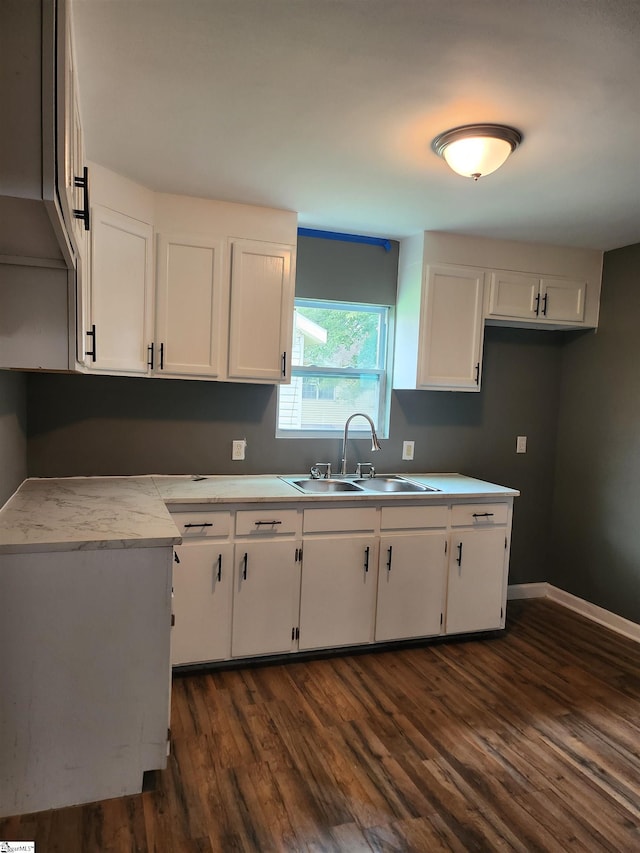 kitchen with dark hardwood / wood-style flooring, sink, and white cabinets