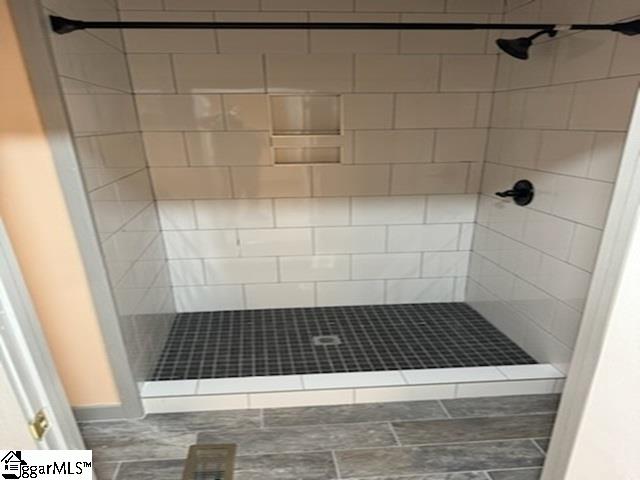 bathroom with a tile shower