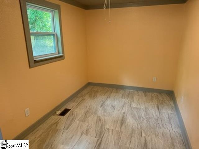 empty room with light hardwood / wood-style flooring