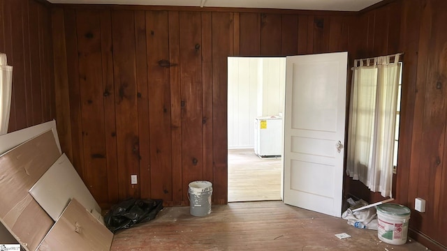 interior space with wooden walls and hardwood / wood-style floors