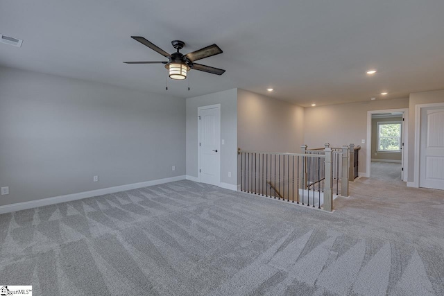 spare room featuring baseboards, recessed lighting, visible vents, and light colored carpet