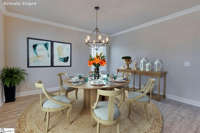 dining space with light wood-style flooring, baseboards, and crown molding