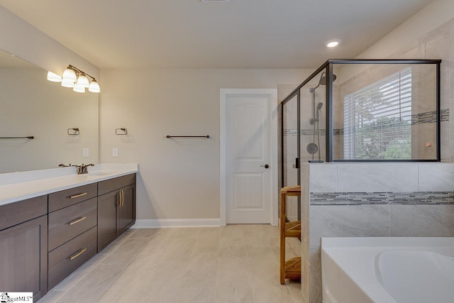 full bath featuring a bath, a shower stall, vanity, and baseboards