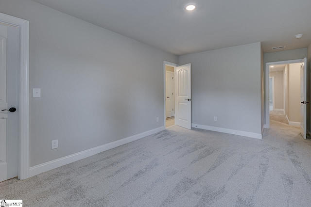 unfurnished bedroom featuring baseboards and light colored carpet