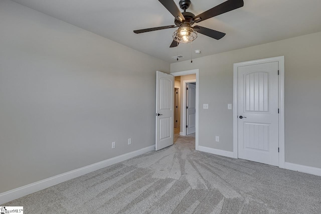 unfurnished bedroom with a ceiling fan, light colored carpet, and baseboards