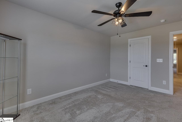 unfurnished bedroom with baseboards, a ceiling fan, and light colored carpet