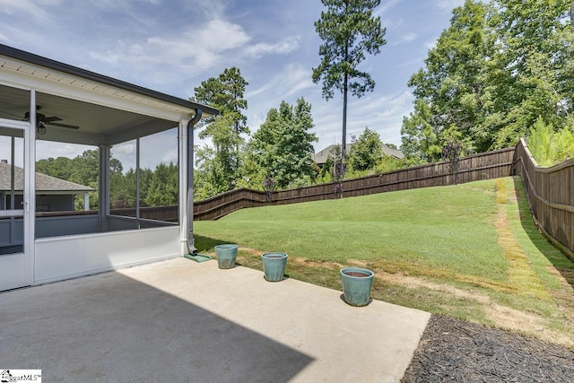 view of yard featuring a sunroom, a fenced backyard, and a patio