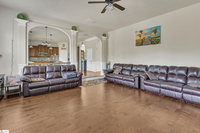 living room featuring ceiling fan and hardwood / wood-style flooring