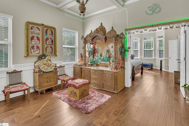 living area with hardwood / wood-style flooring and coffered ceiling