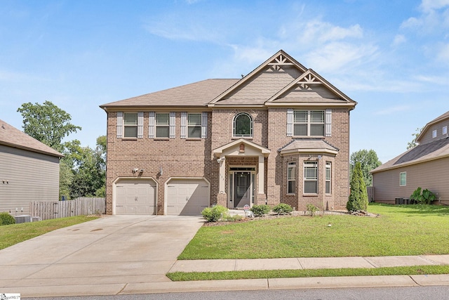 view of front of property with a garage, central AC unit, and a front yard