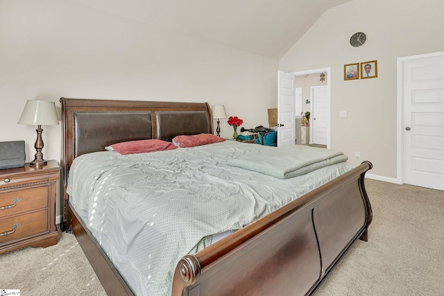 bedroom with lofted ceiling and light colored carpet