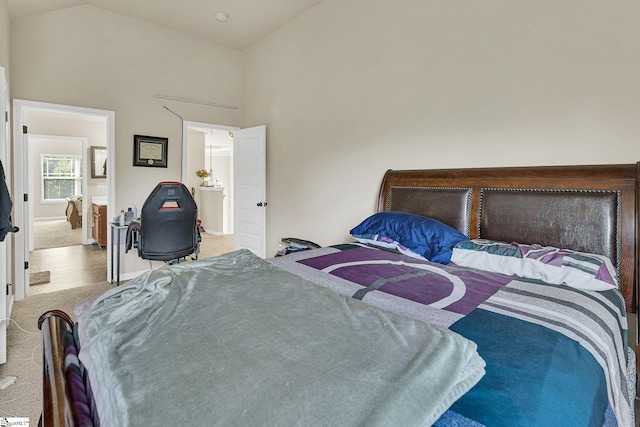 carpeted bedroom with high vaulted ceiling