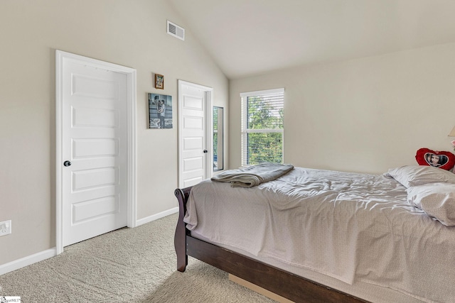 carpeted bedroom featuring vaulted ceiling