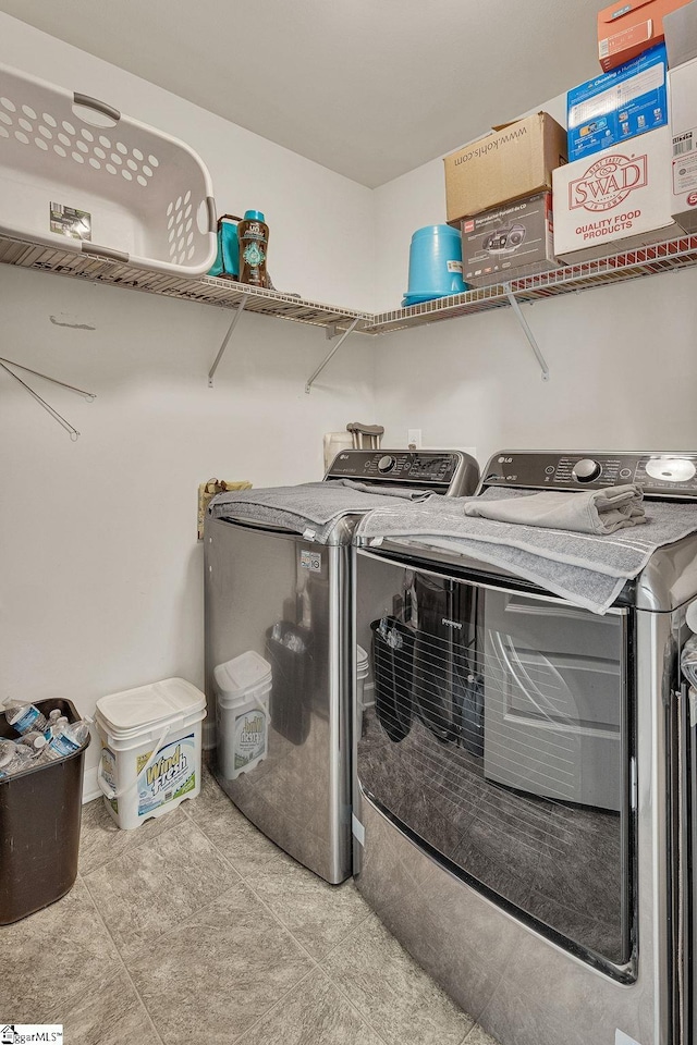 laundry room with separate washer and dryer and light tile patterned floors