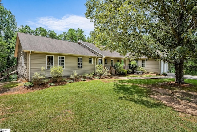 single story home with a front lawn and roof with shingles