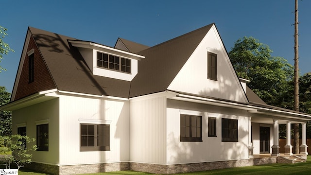 rear view of house with a lawn and covered porch