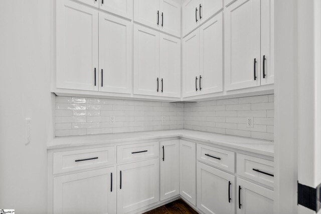 1 Mapleton Dr, Greenville, SC 29607 - kitchen with white cabinetry, decorative backsplash, light stone counters, and dark wood-type flooring
