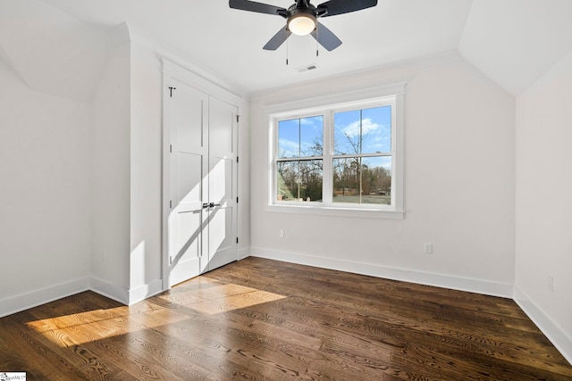 interior space with lofted ceiling, dark hardwood / wood-style floors, and ceiling fan