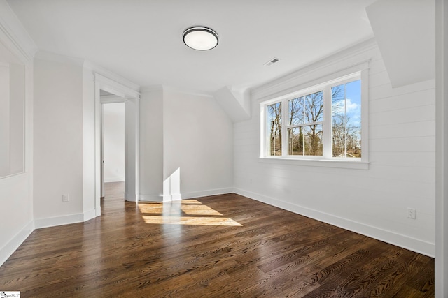 additional living space with dark hardwood / wood-style flooring