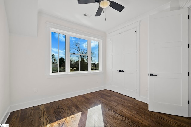 unfurnished bedroom featuring dark hardwood / wood-style flooring, a closet, and ceiling fan