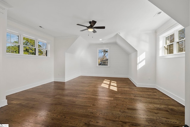 bonus room with a healthy amount of sunlight, dark wood-type flooring, and ceiling fan