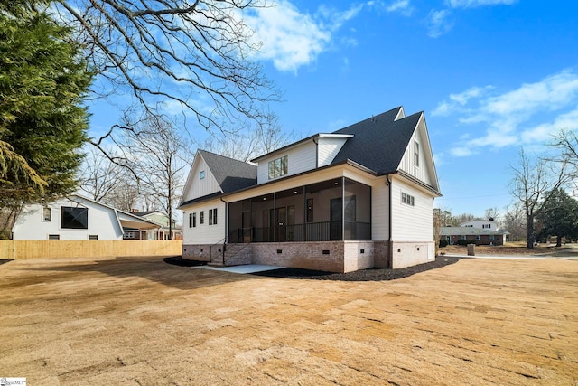 exterior space with a sunroom and a lawn