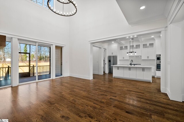 1 Mapleton Dr, Greenville, SC 29607 - unfurnished living room featuring a chandelier, a sink, dark wood-style floors, baseboards, and recessed lighting