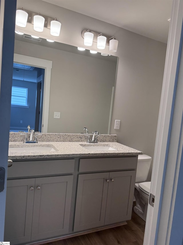 bathroom featuring hardwood / wood-style flooring, vanity, and toilet